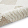 image of white and beige checkered rug rolled up on one end