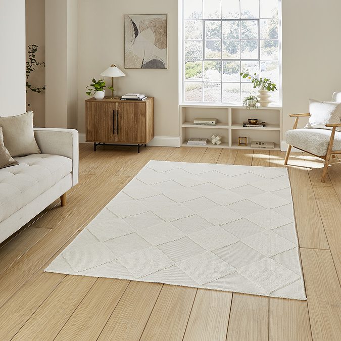 image of cream checkered rug on light wooden flooring of modern loft apartment