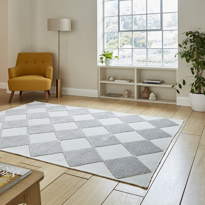 angled image of cream and grey checkered diamond rug