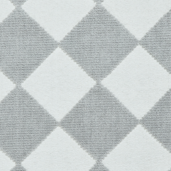 close up image of cream and grey checkerboard rug
