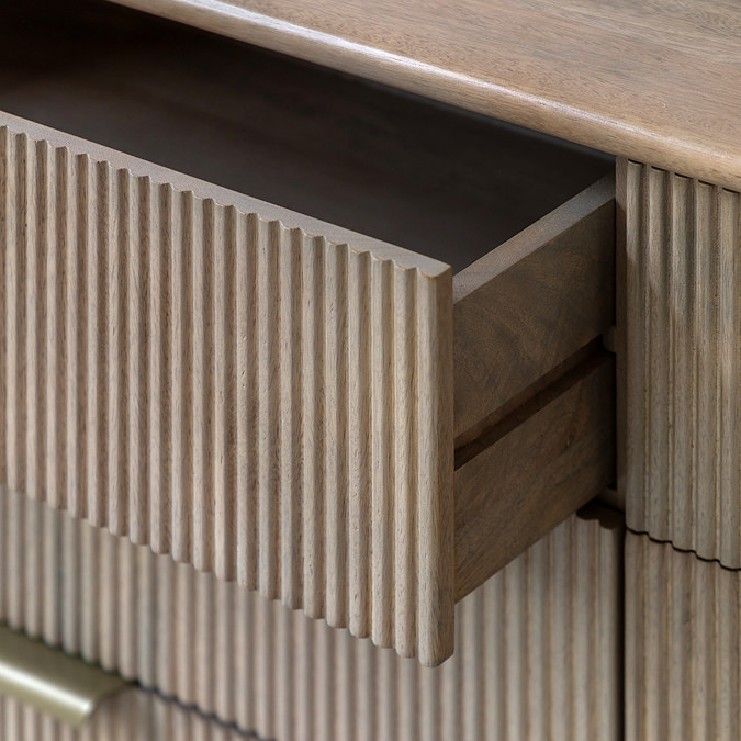 close up image of fluted mango wood drawers, open to reveal hinge contraption