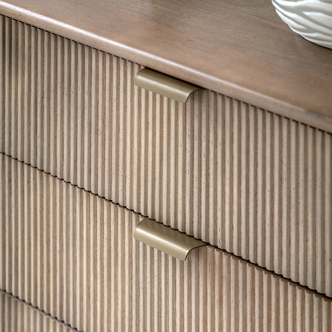 close up image on fluted mango wood drawers with brass handles