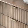 close up image on fluted mango wood drawers with brass handles
