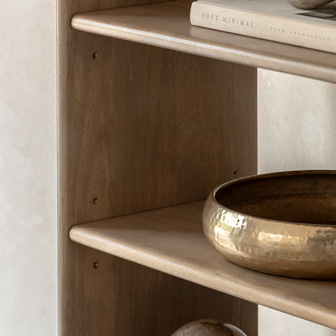 close up image of smooth mango oak shelves of unit, with decorative gold bowl on shelf