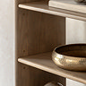 close up image of smooth mango oak shelves of unit, with decorative gold bowl on shelf