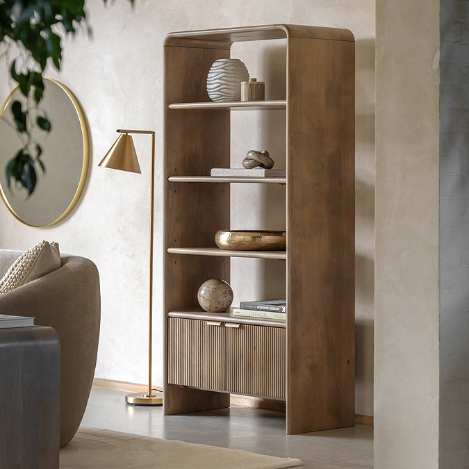 image of mango wood open shelving unit with two fluted drawers at the bottom, against a cream wall in a living room