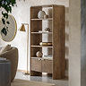 image of mango wood open shelving unit with two fluted drawers at the bottom, against a cream wall in a living room
