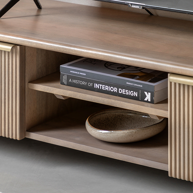 close up image of mango wood media unit middle shelf with book on it