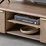 close up image of mango wood media unit middle shelf with book on it