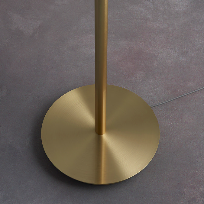 image of brushed gold circular base of floor lamp