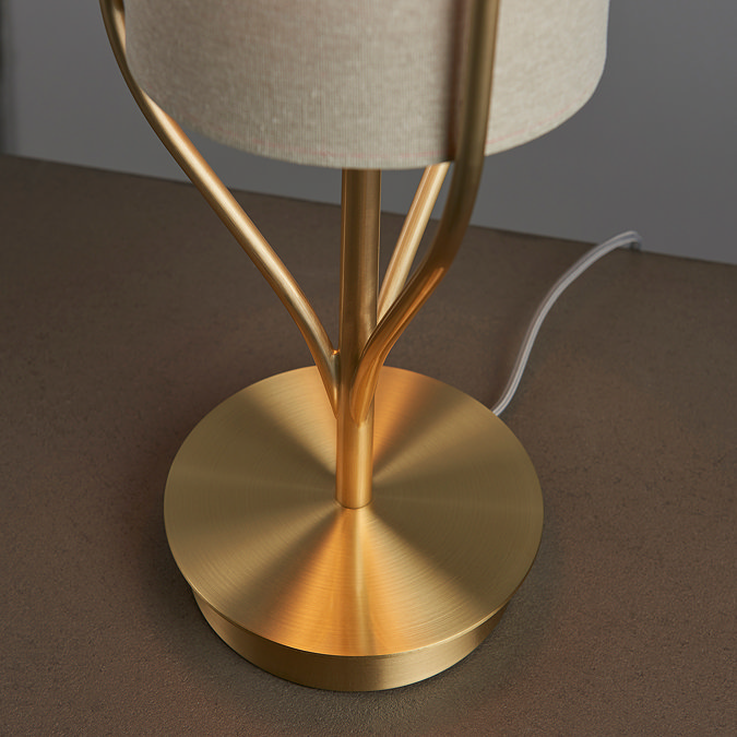 close up on brushed gold base of conical table lamp