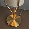 close up on brushed gold base of conical table lamp