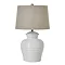 image cut out on white background of rounded white ceramic table lamp with linen fabric shade