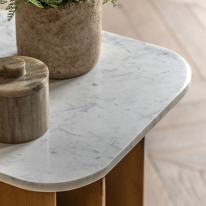 close up on marble tabletop of square side table with gold metal base