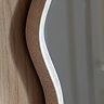 close up image of side of light grey wavy wall mirror