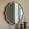 image of soft washed grey wavy mirror on light wood wall