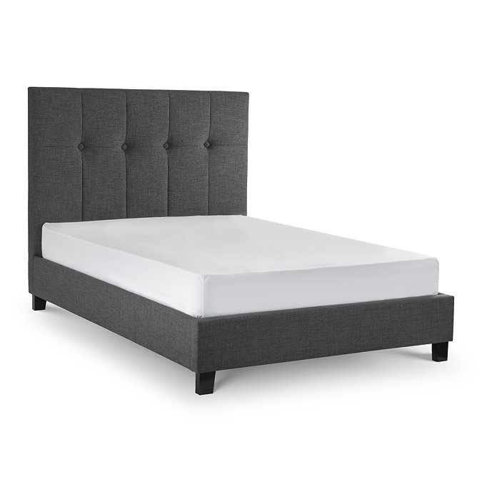 image cut out on white background of slate grey fabric bed with high headboard
