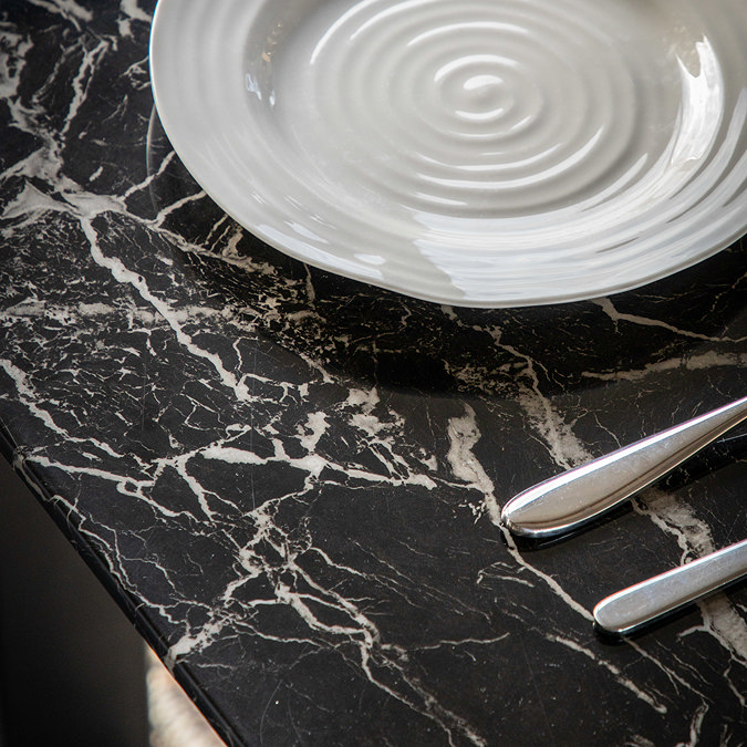 close up on marble effect of black glass dining table