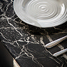 close up on marble effect of black glass dining table