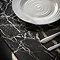 close up on marble effect of black glass dining table