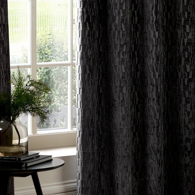 Manhattan Eyelet Curtains in Charcoal over a window close up image
