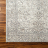 close up image on corner of grey vintage rug with vintage floral pattern