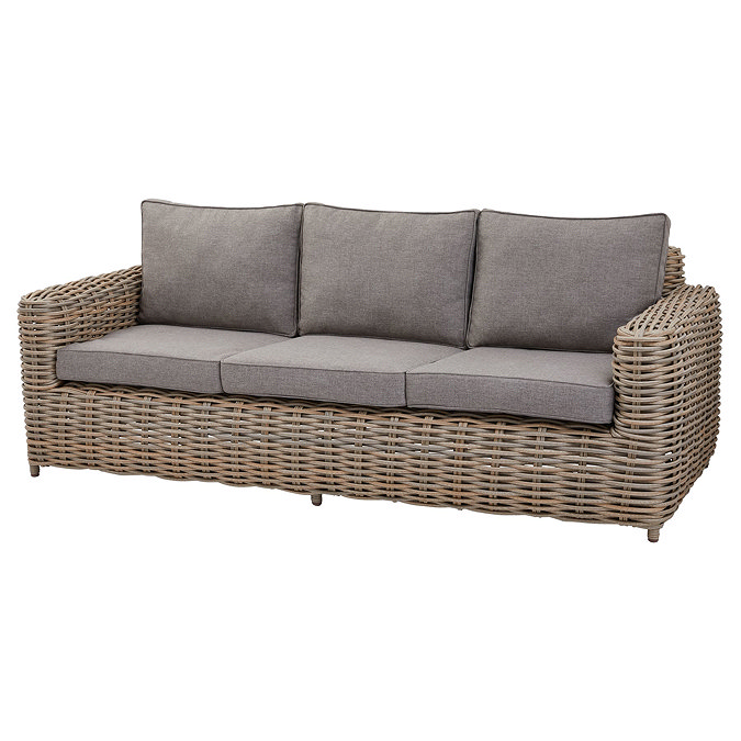 image cut out on white background of rattan 3 seater lounge sofa, with plush grey cushions