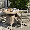 image of bistro table with wicker chair next to it on garden patio