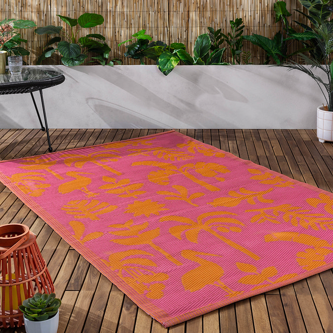 Marula outdoor rug in pink and orange on floor image 1