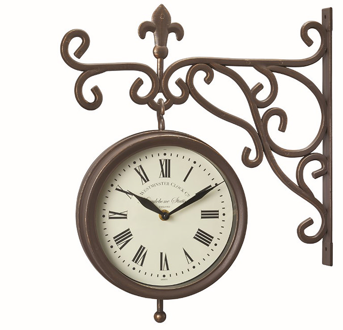 image cut out on white background of brown station clock with intricate arm and round face