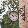 image of classic station wall clock with intricate hand, round face and roman numerals