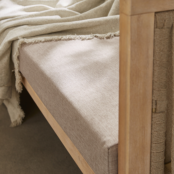 super close up image of beige sofa seats of outdoor sofa set, with warm wood