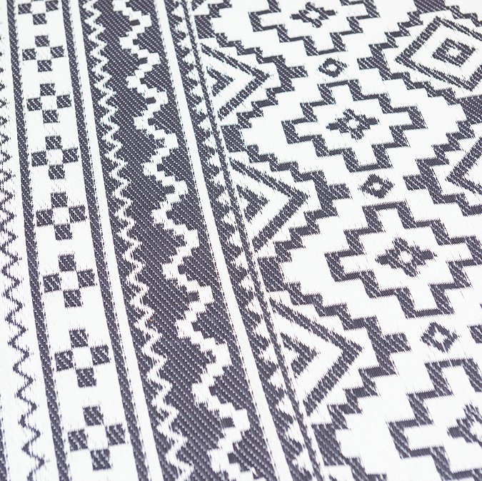 close up zoomed in image of slate grey rug with Aztec pattern