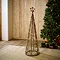 medium sized brown wicker christmas tree with star on top, stood on rug in living room
