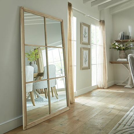 Merano Washed Wood XL Window Mirror lifestyle image against a wall