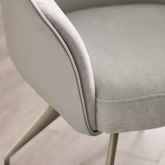 close up image on corner of light grey chenille chair with leather PU back