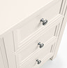 close up on drawers of off-white dressing table with silver metal round handles