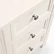 close up on drawers of off-white dressing table with silver metal round handles