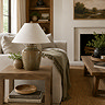 wide shot of mottled green lamp on side table of living room