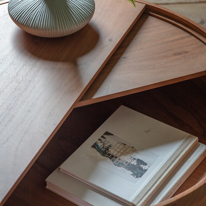 close up on inside of coffee table storage drawer with books inside