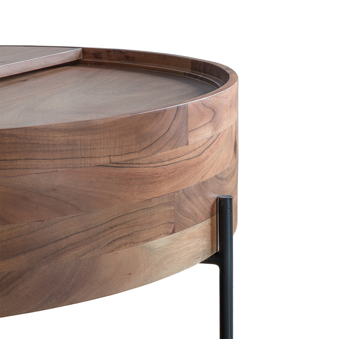 close up image of curved edge of round brown wood coffee table