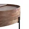 close up image of curved edge of round brown wood coffee table