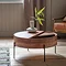 image of round wood storage coffee table, with half its top moveable to reveal drawer to put things in, pant on top