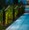 wide image of modern stake lights emitting cool white light onto path