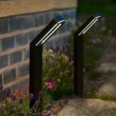 image of modern stake lights on border of garden pathway emitting warm white light
