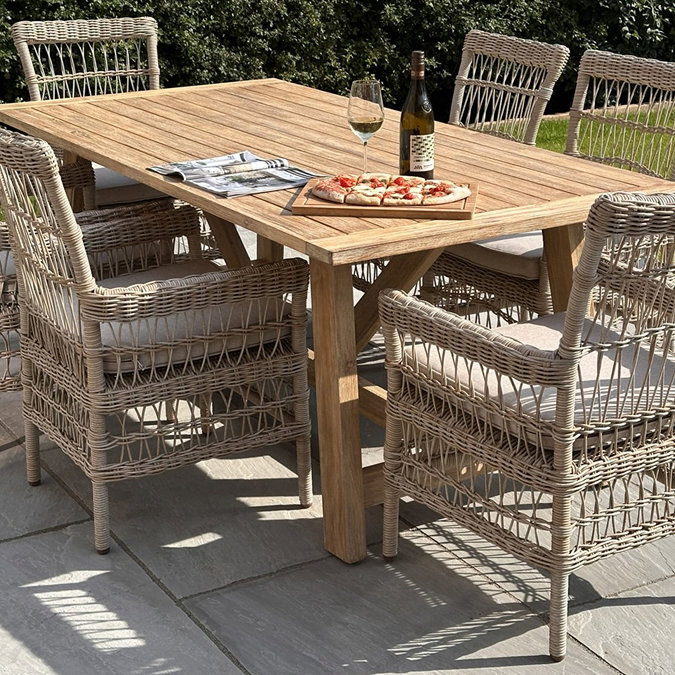 image of rectangular 6 seater acacia wood dining table on a garden patio