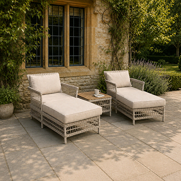 close up image of two beige sun loungers with square coffee table between them
