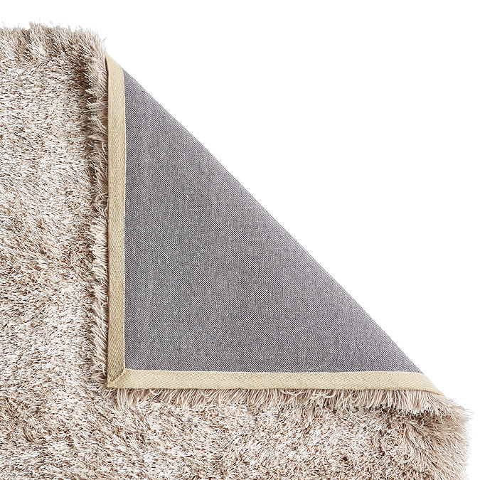 image of beige rug with corner folded over to show material underneath