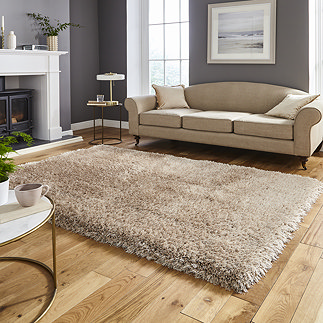 image of large rectangular shaggy beige rug in front of beige sofa