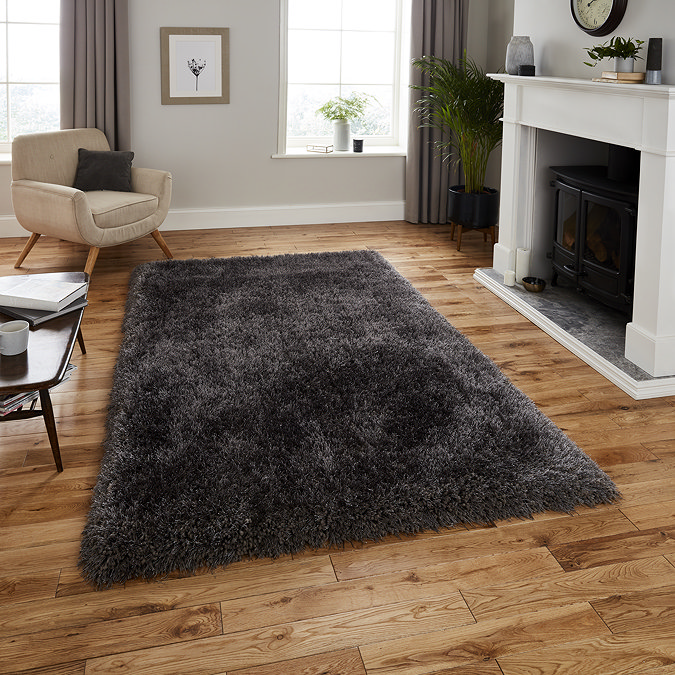 image of dark grey shaggy rug on light wooden floor in modern apartment